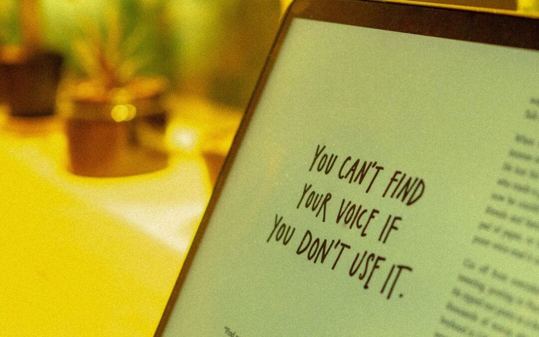 A computer screen with the following saying displayed, “You can’t find your voice if you don’t use it.”