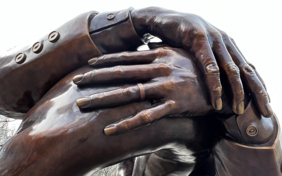 A close-up image of “The Embrace” sculpture in Boston Commons.