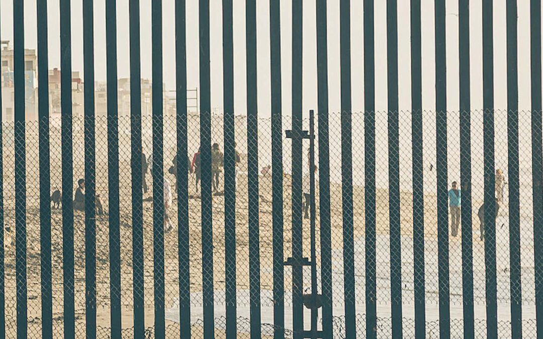 A border fence along the U.S.-Mexico border just south of San Diego, California at the Pacific Ocean.