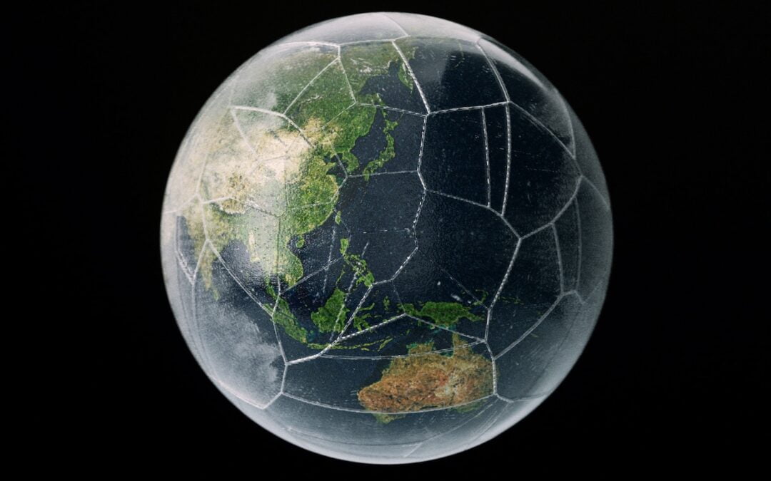 A model of Earth within a cracked glass globe.