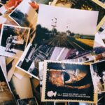 Old photographs in a pile on a table.