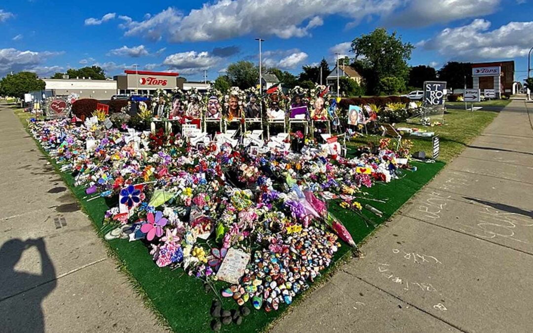A memorial with flowers and other items to the victims of the mass shooting at a Tops supermarket in Buffalo, New York.