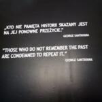 A sign outside the Auschwitz concentration camp displaying a quote by George Santayana.