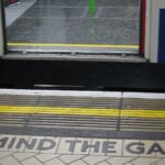 A “mind the gap” sign in the tile floor of the London Underground Victoria Station.