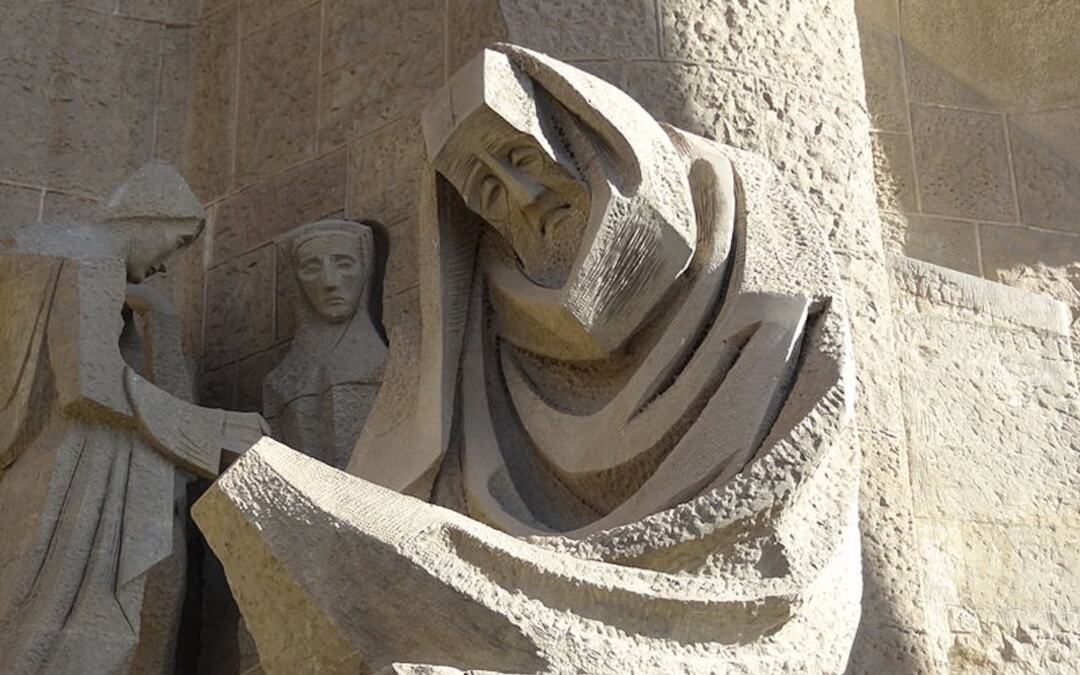 A sculpture of Peter weeping after betraying Jesus, which is part of the Passion Facade of the Sagrada Família in Barcelona.