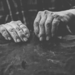 Man’s hands in grayscale.