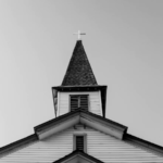 A church steeple in grayscale.
