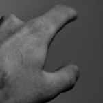 A man pointing his finger in grayscale