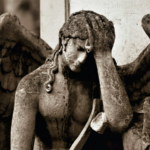 A stone image of an angel grieving