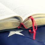 A Bible rests on top of a U.S. flag.