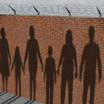 A depiction of shadows of immigrants cast on a brick wall with razor wire