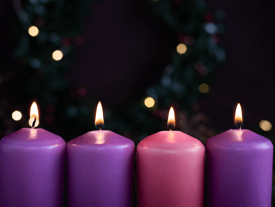 Four lit Advent candles.