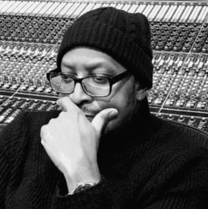 A photo of Marquis Hunt in front of a sound board.