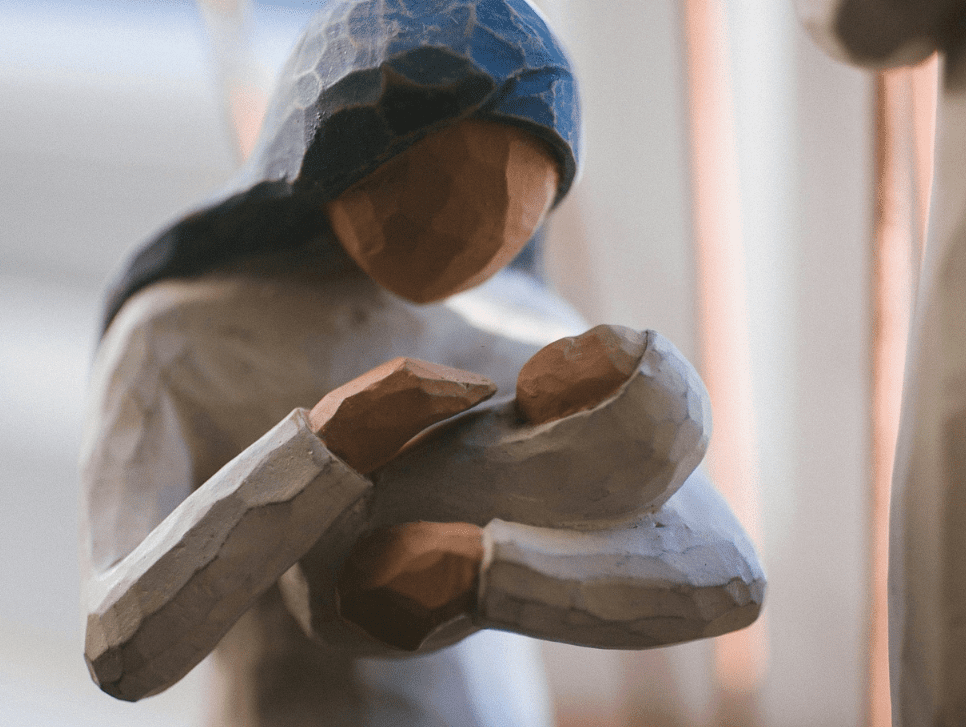 A carved wooden figure of Mary with the baby Jesus.