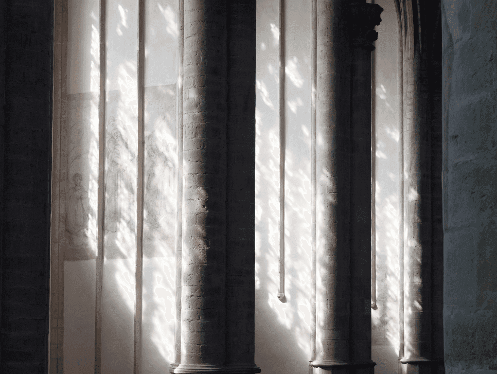 A photo of light coming in through arch windows.