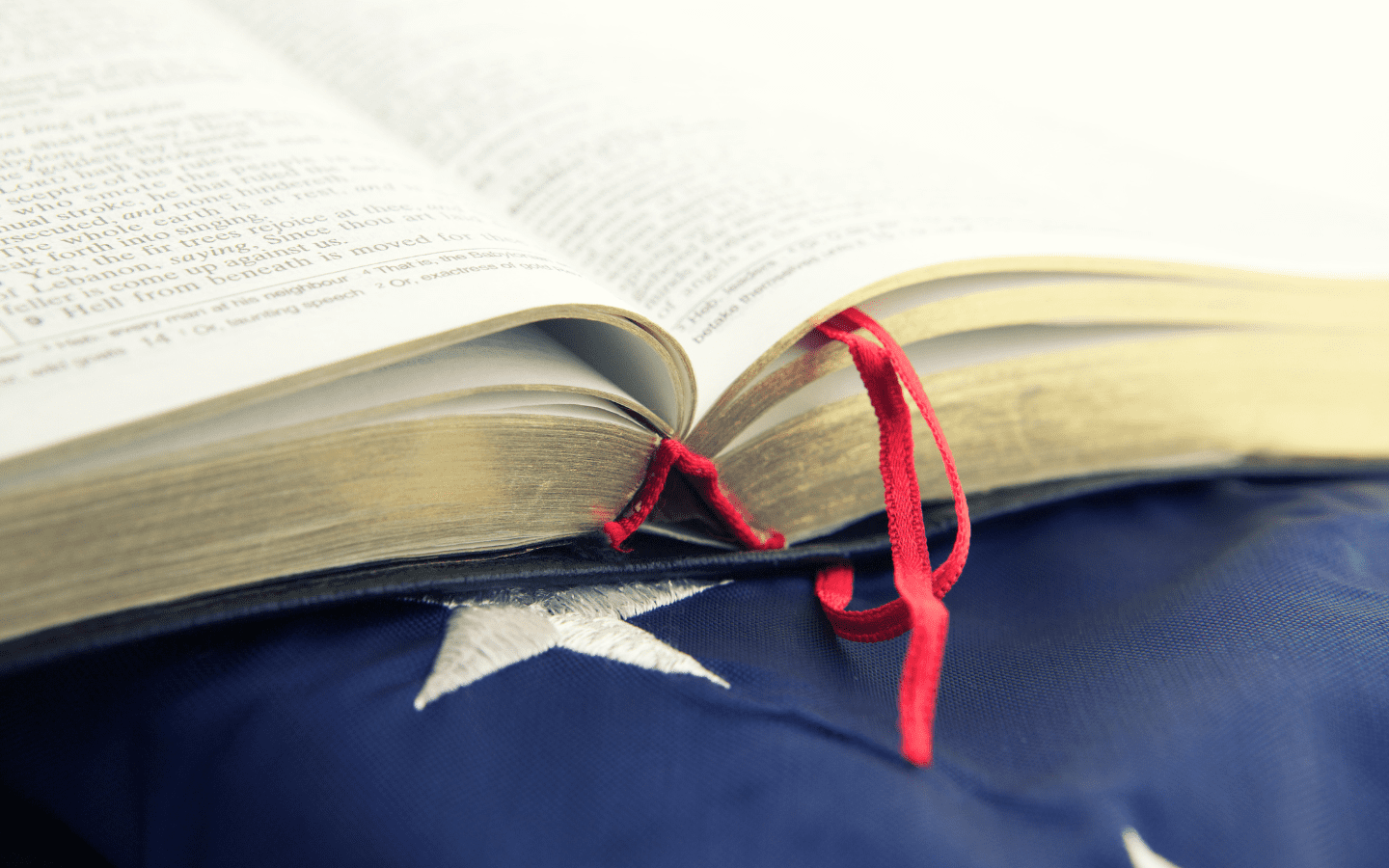 A Bible rests on top of a U.S. flag.
