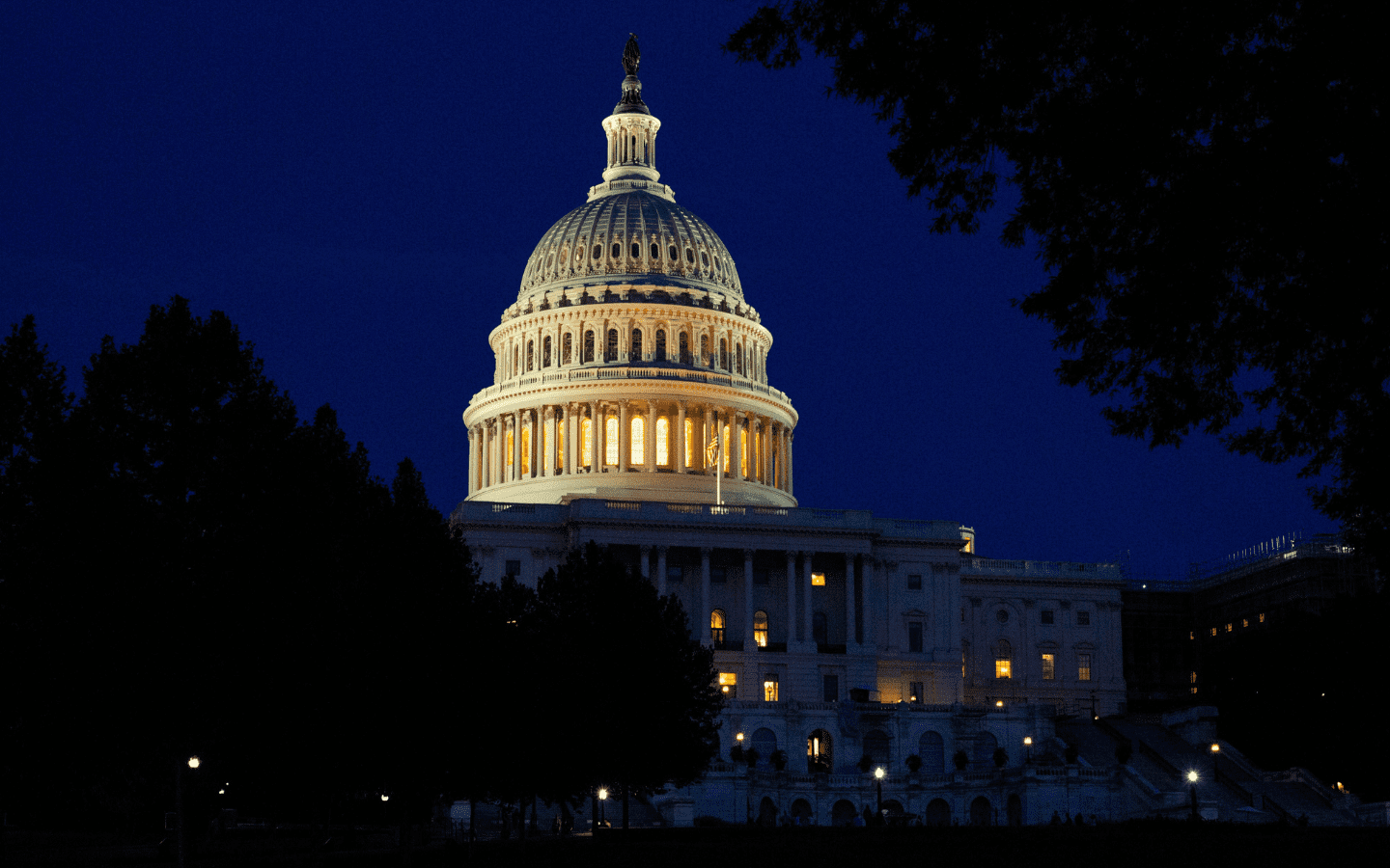 A night-time photo of the exterior of the U.S. Capitol Rotunda.