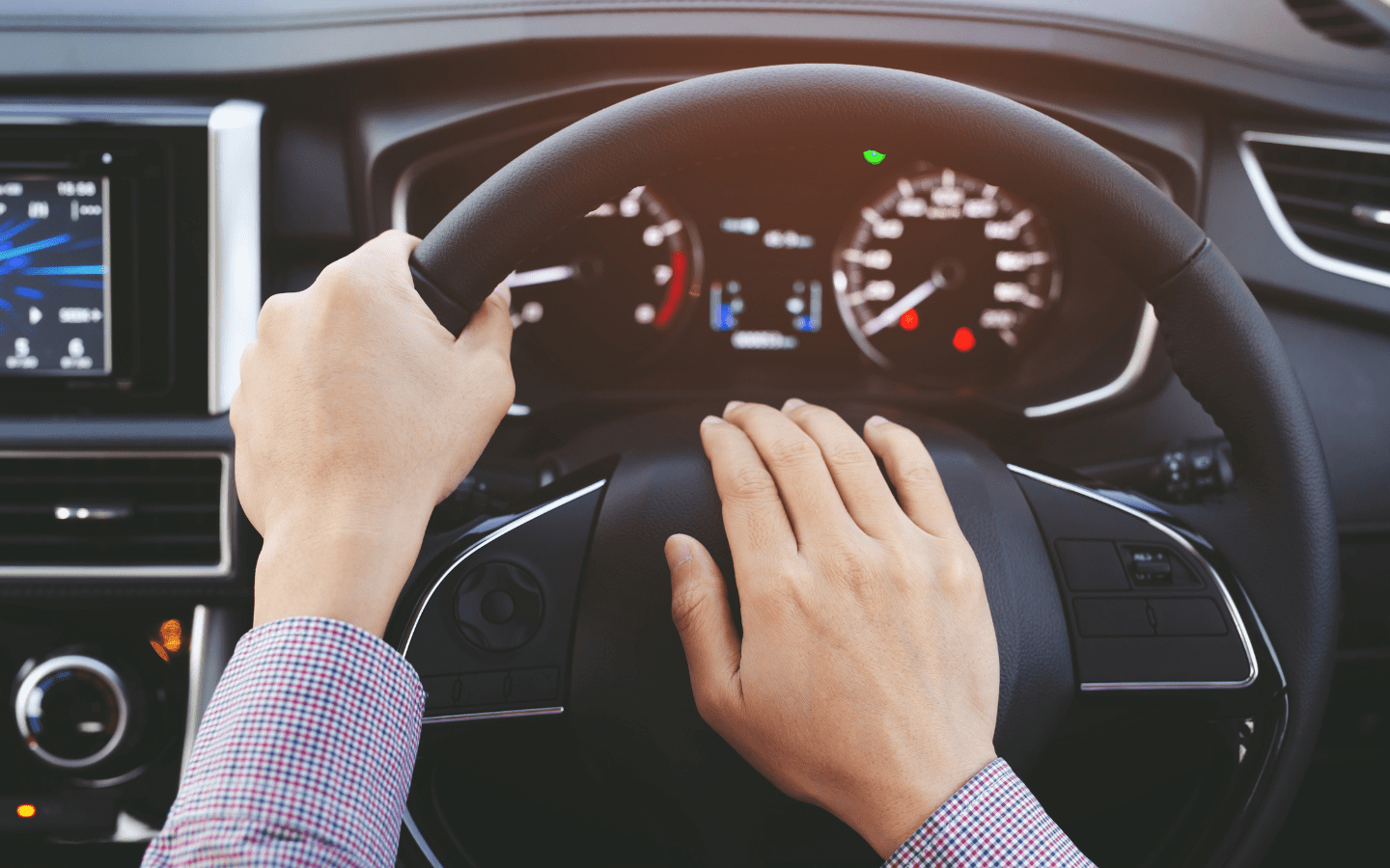 A man has his hand on his car horn.