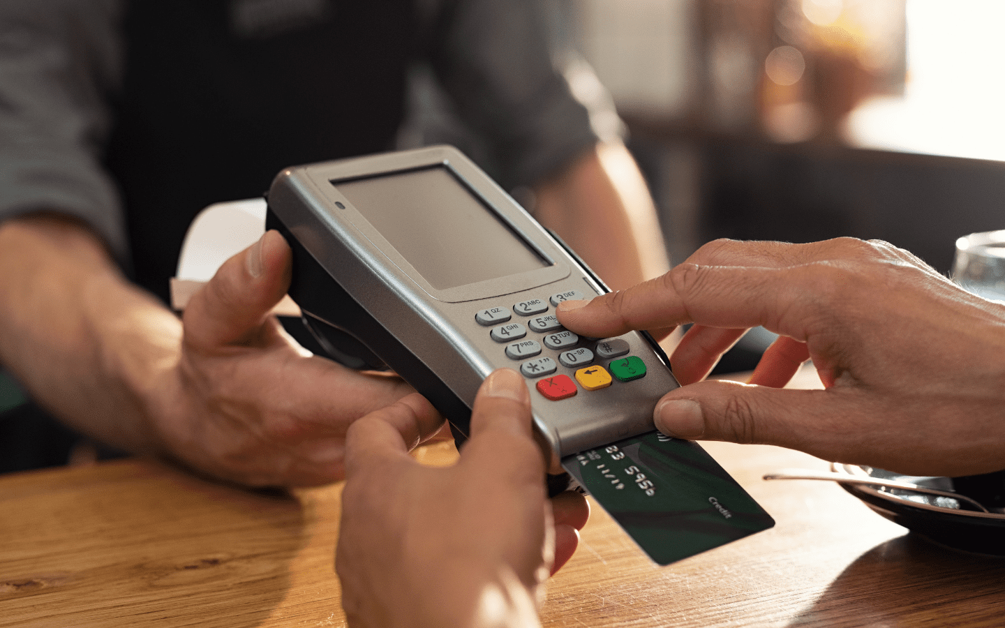 A photo of a debit card machine being used.