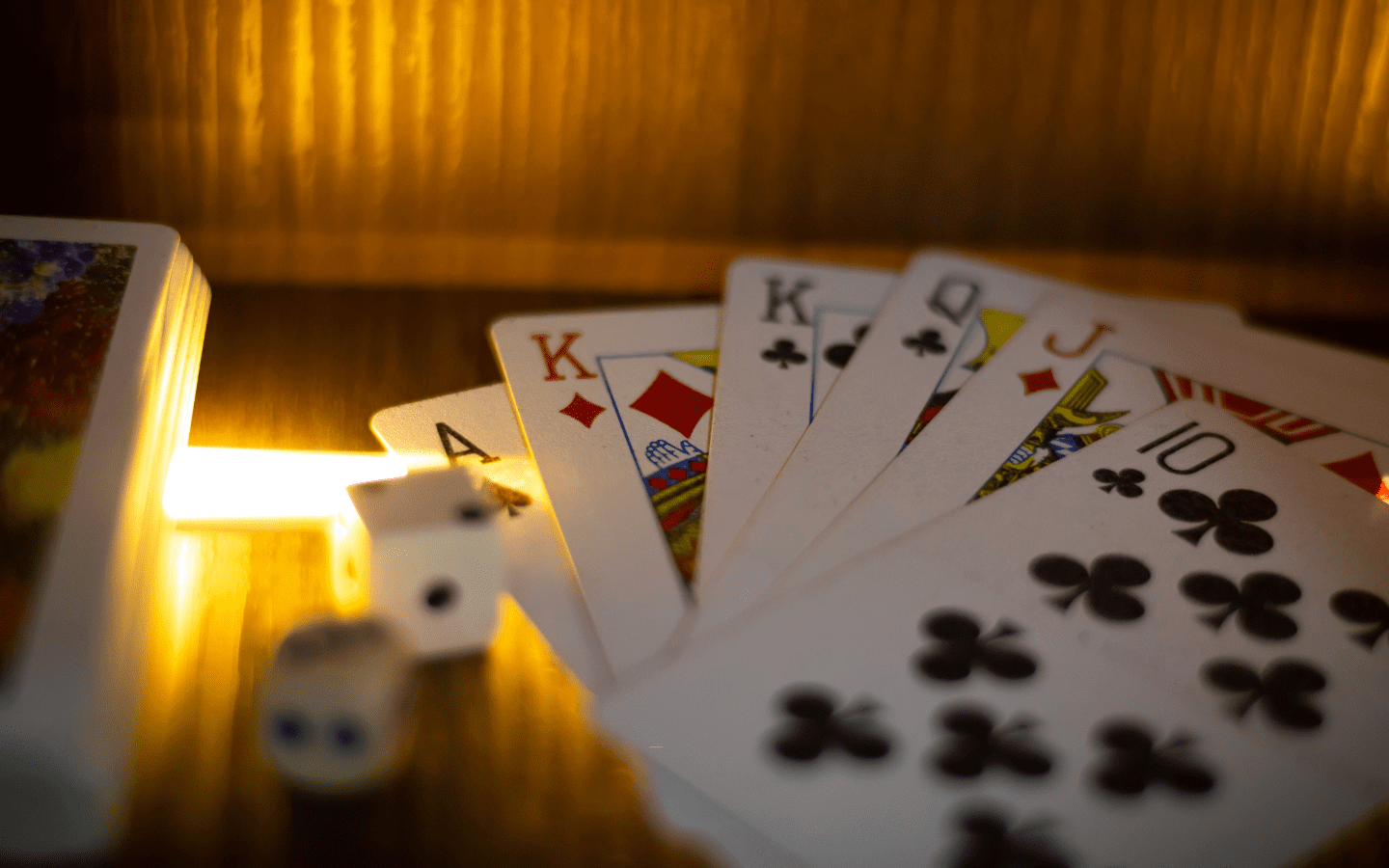 A deck of cards spread out with dice.