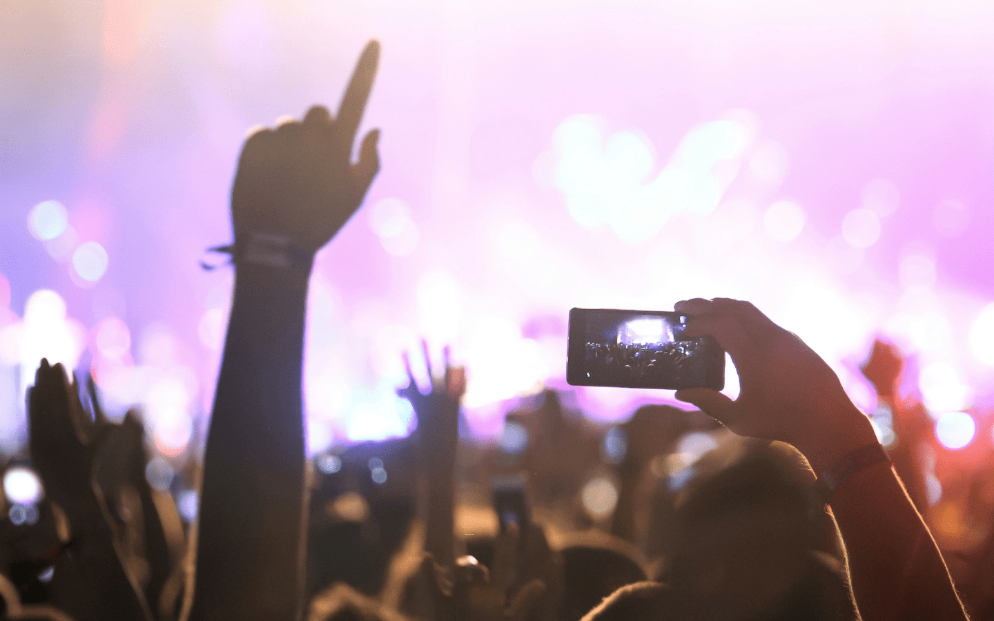 A concert with attendees recording the musical act on their phones.