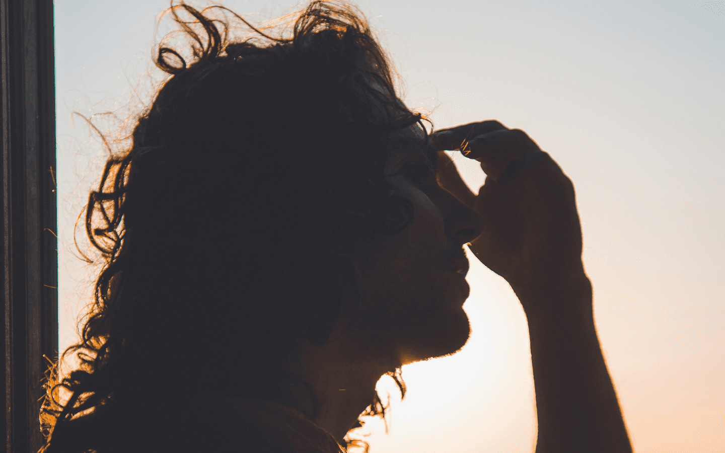A person holding their head and depicting what it is like living in chronic pain.|A person holding their head and depicting what it is like living in chronic pain.