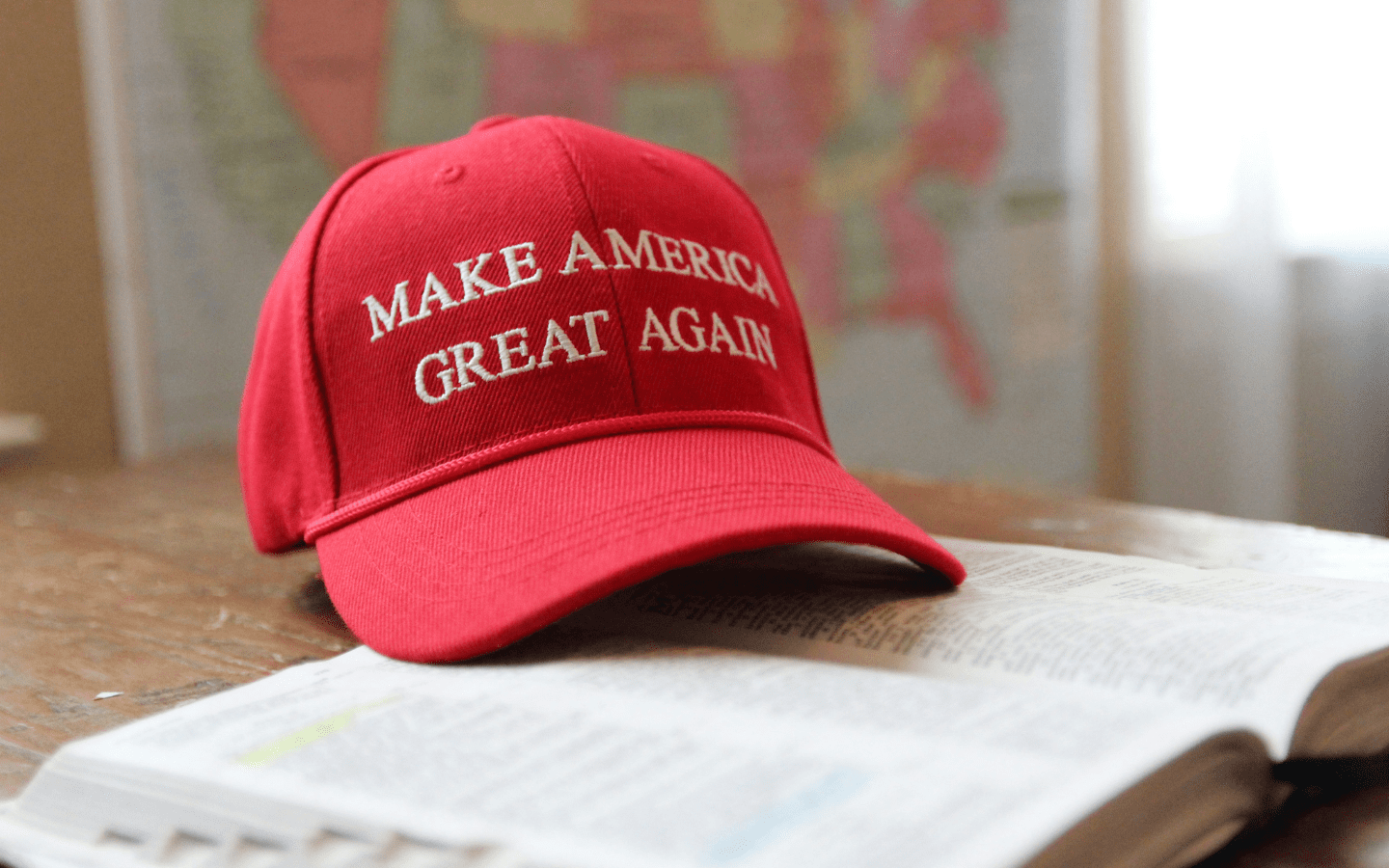 A photo of a red MAGA hat on a Bible