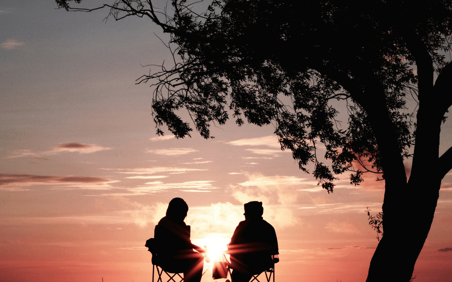 A photo of an elderly couple enjoying a sunset.