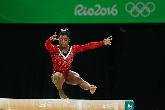 A photo of Simone Biles competing on the balance beam at the 2016 Olympics.