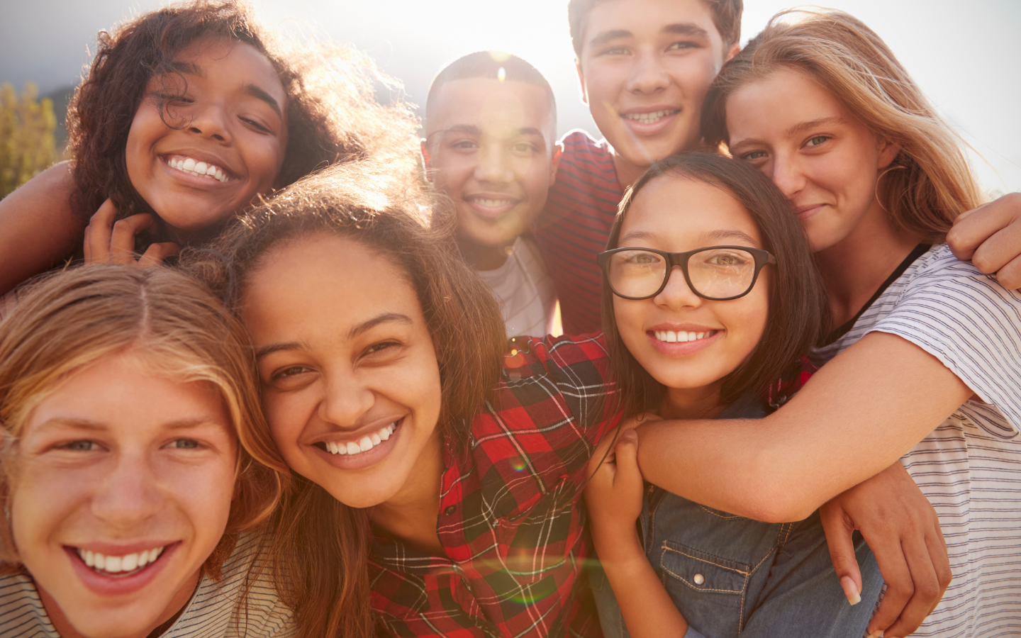 A group of teenagers smiling for a camera.