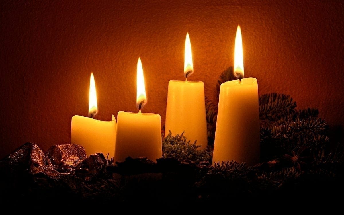 Four lit candles of Advent