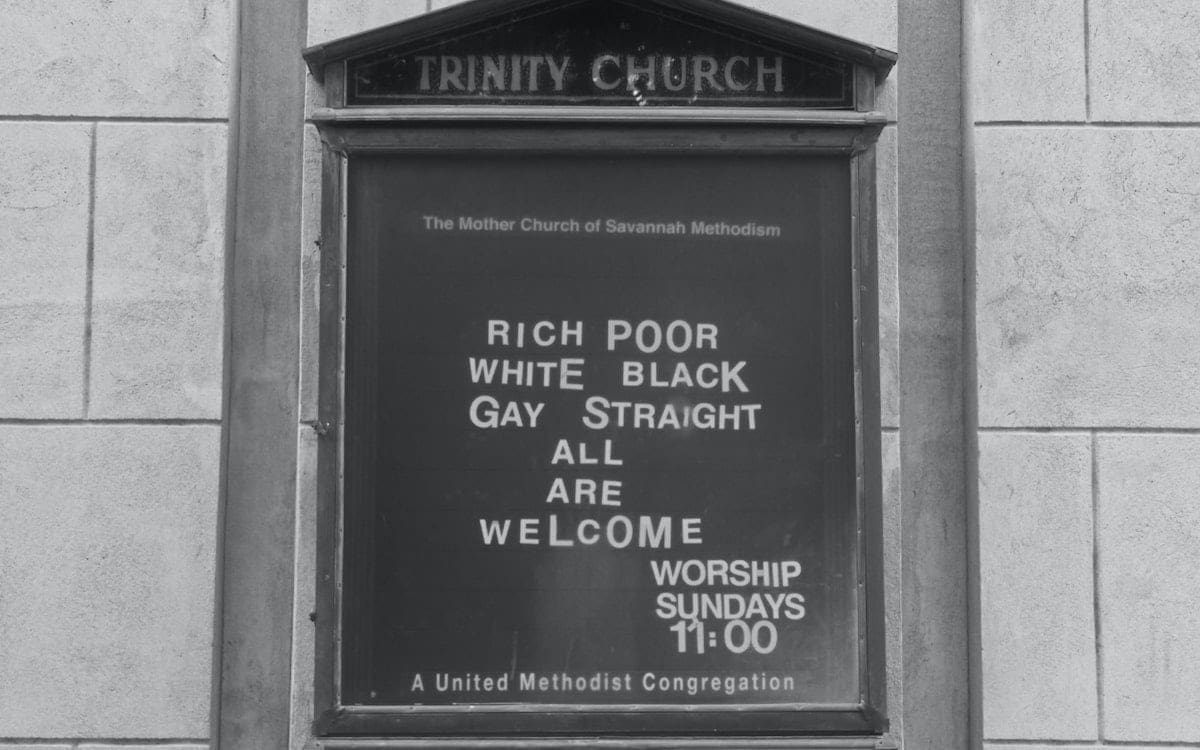 A black and white image of a church sign that says
