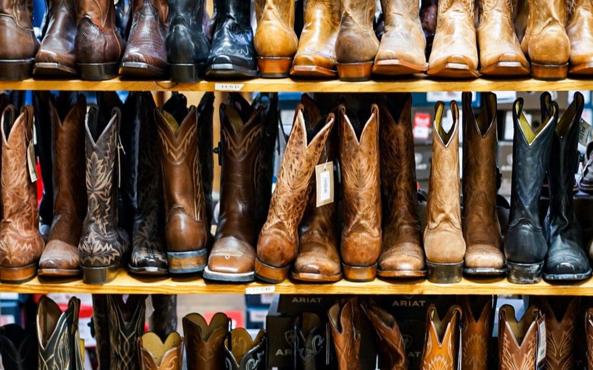 Shelves of boots in a store.