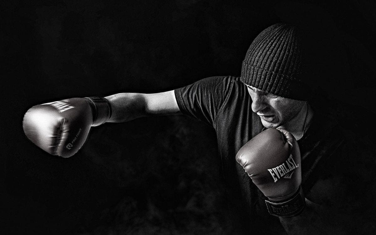 Gloved boxer punching the air