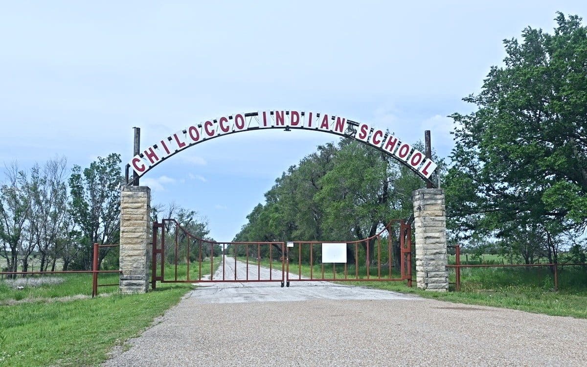 The entrance to the campus of Chilocco Indian School in Oklahoma.|A cemetery at the Chilocco Indian Boarding School in Oklahoma.