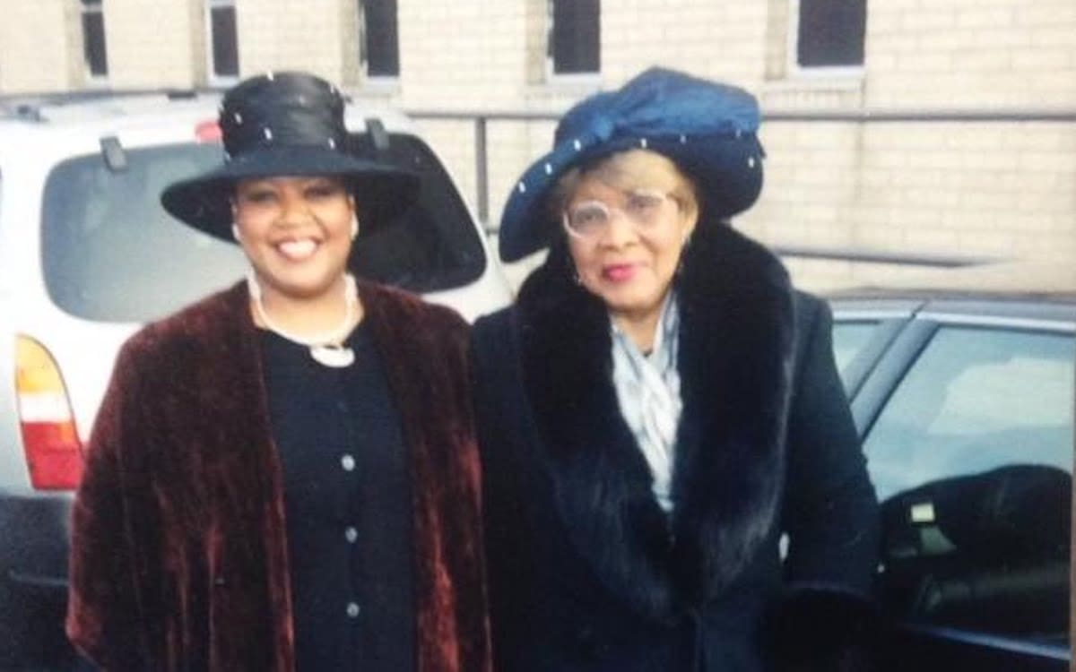 Two women standing together on the street.|