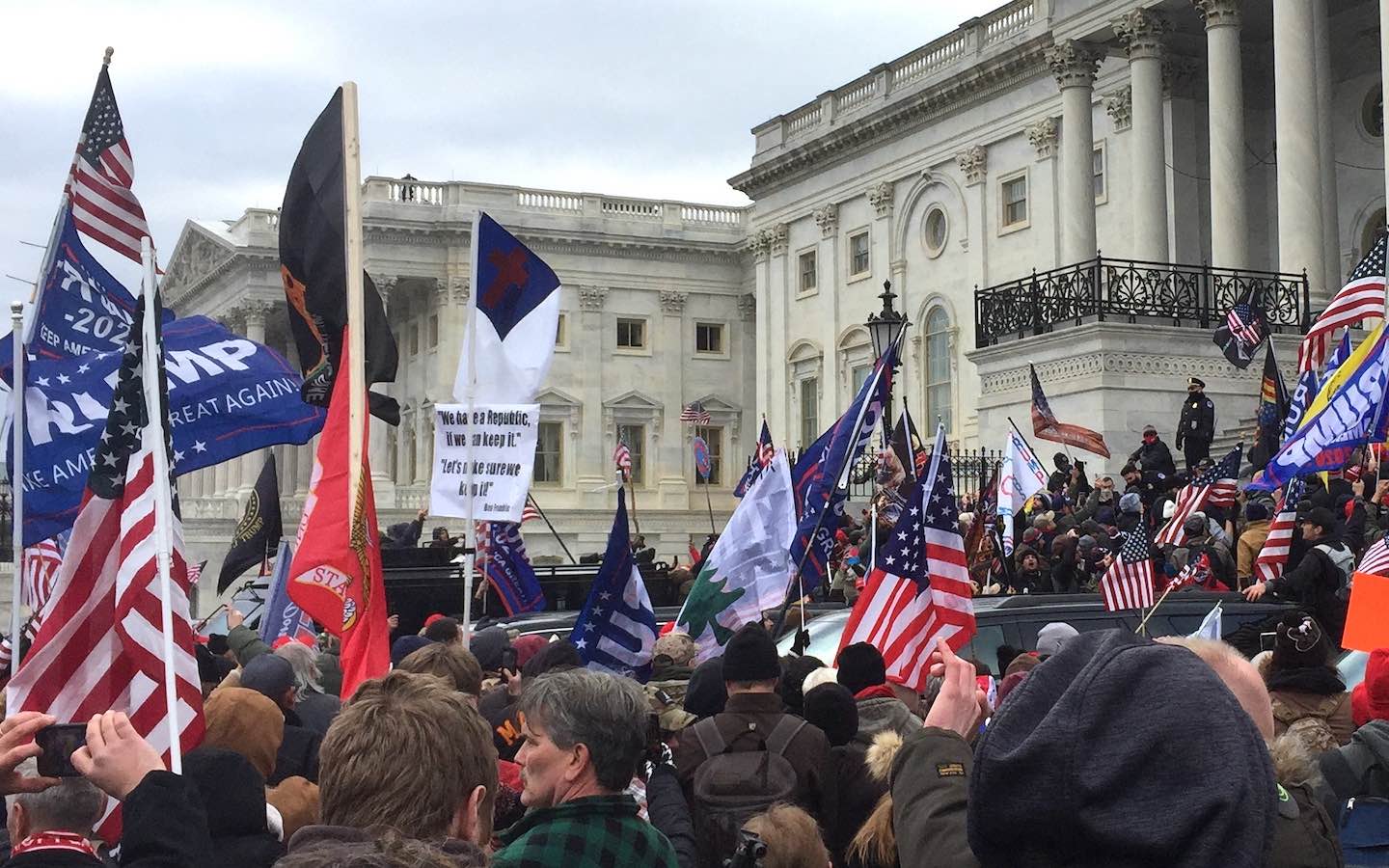 A Christian flag in the middle of the crowd outside the U.S. Capitol on Jan. 6