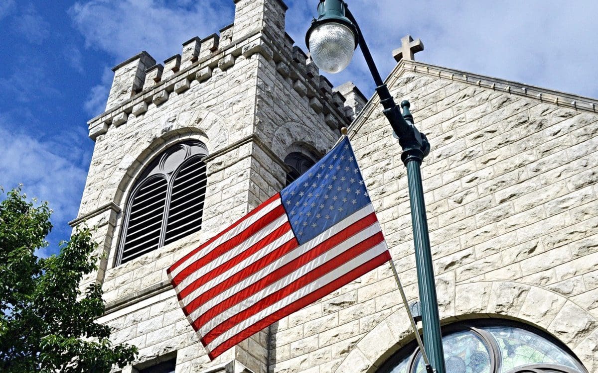 U.S. flag flying in front of church building