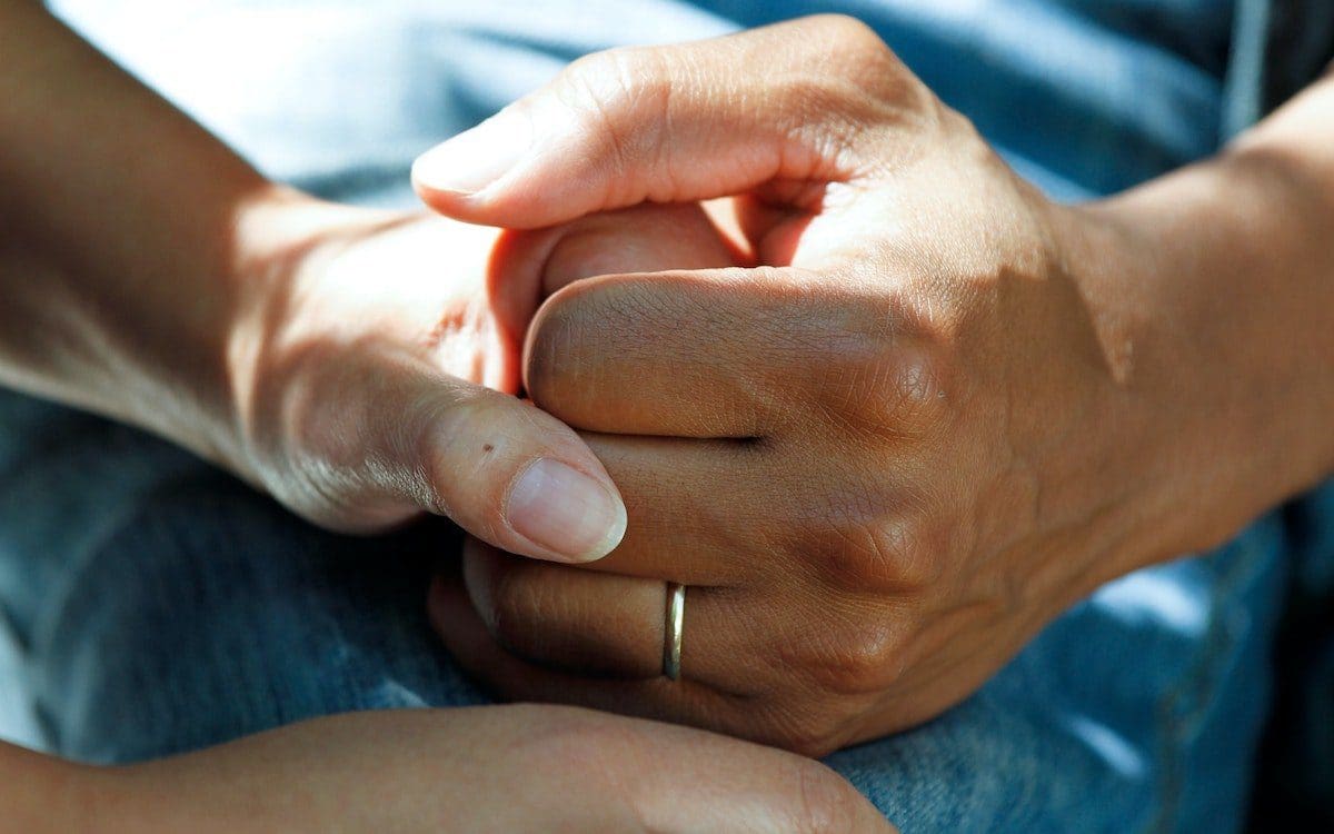 A couple holding hands.