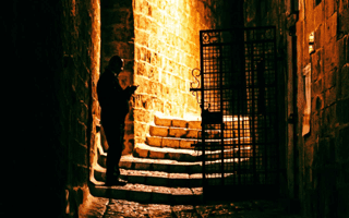 A man alone in a dark alley in Jaffa.