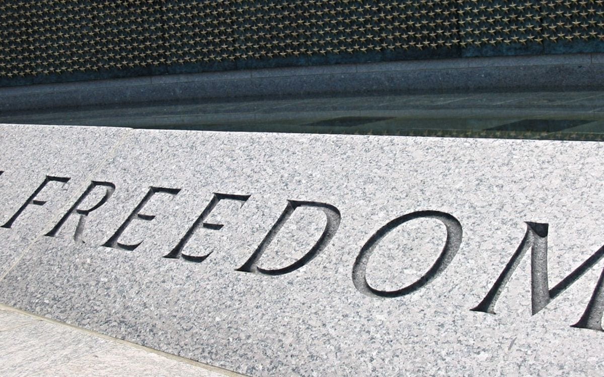 Word freedom engraved in stone