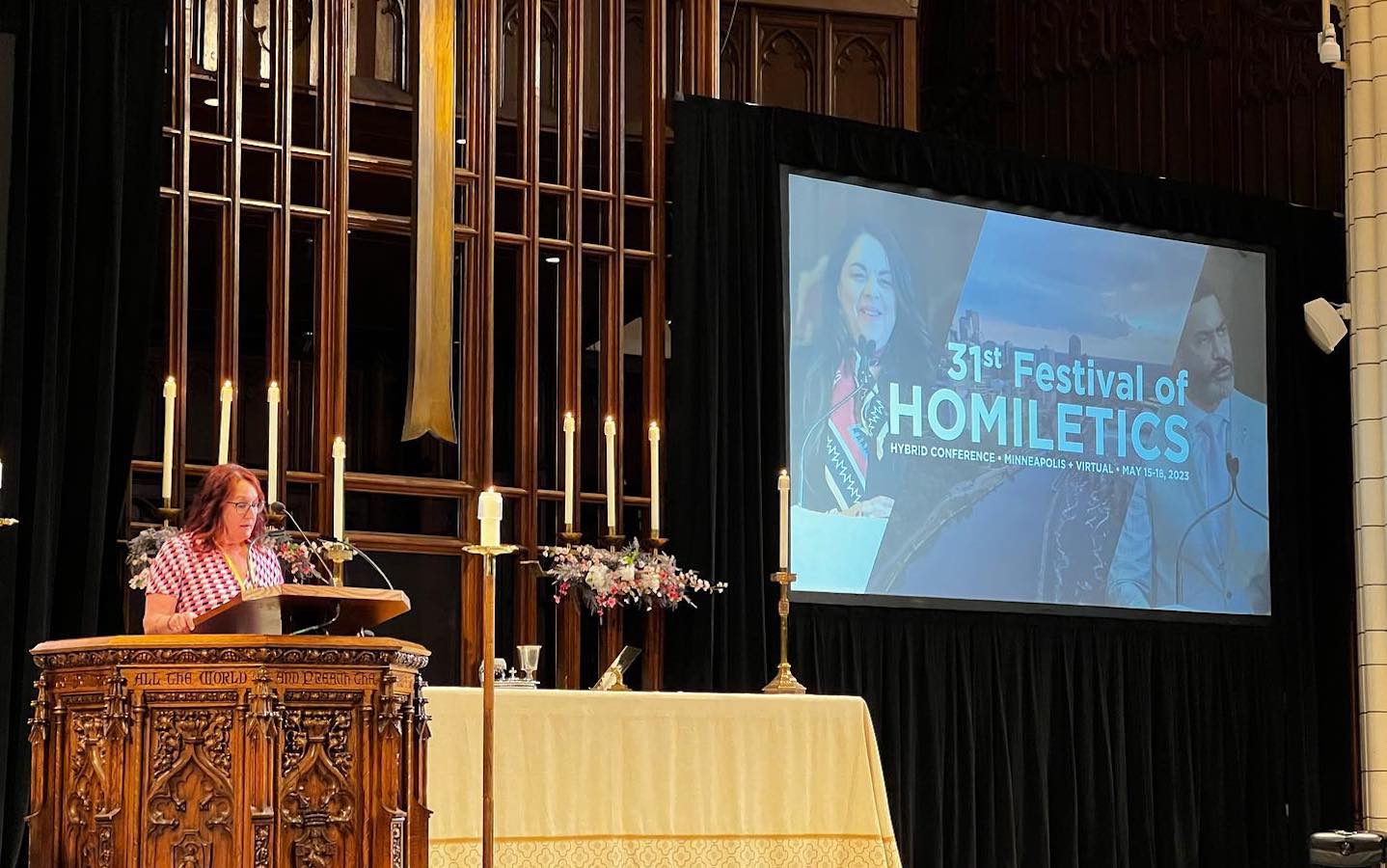 A woman standing behind a pulpit with a graphic on a projection screen.|A man speaking with his arms outstretched.||A woman preaching in a church pulpit.|A woman preaching in a church pulpit.|