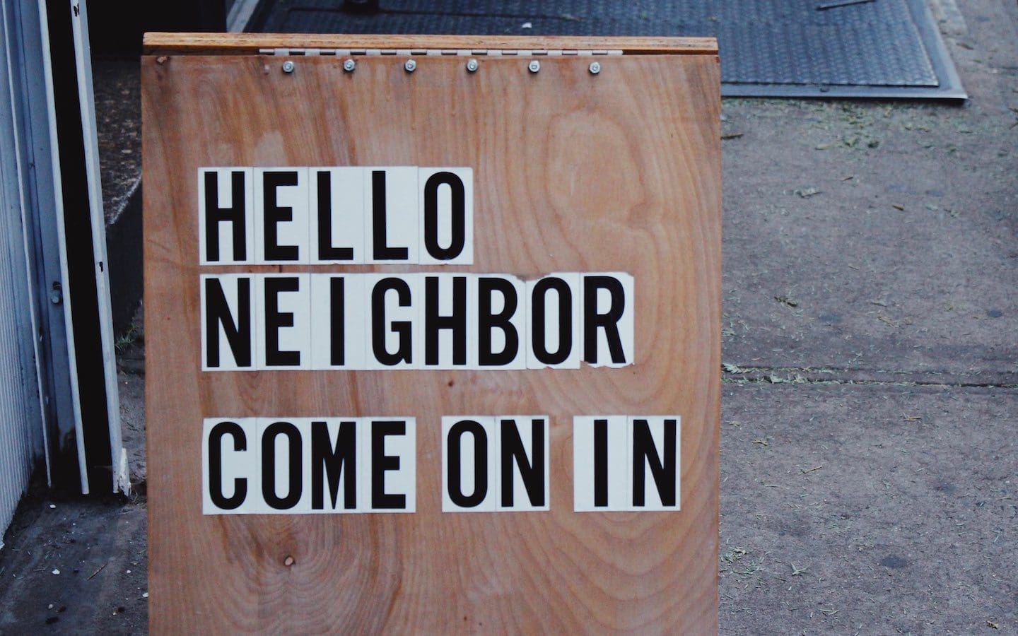 A wooden sign with block lettering that says