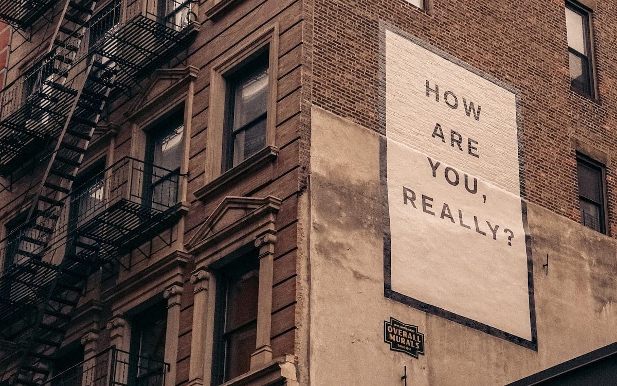 A brick apartment building with the question