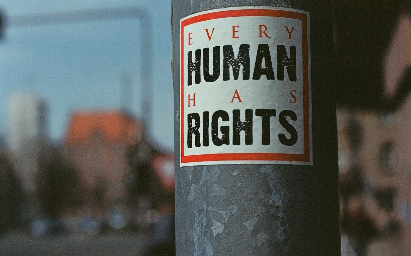 A sign posted on a streetlight pole that says