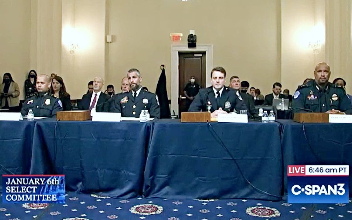 Four police officers sitting at a table waiting to testify during the first hearing of the Select Committee to Investigate the Jan. 6 attack on the United States Capitol.