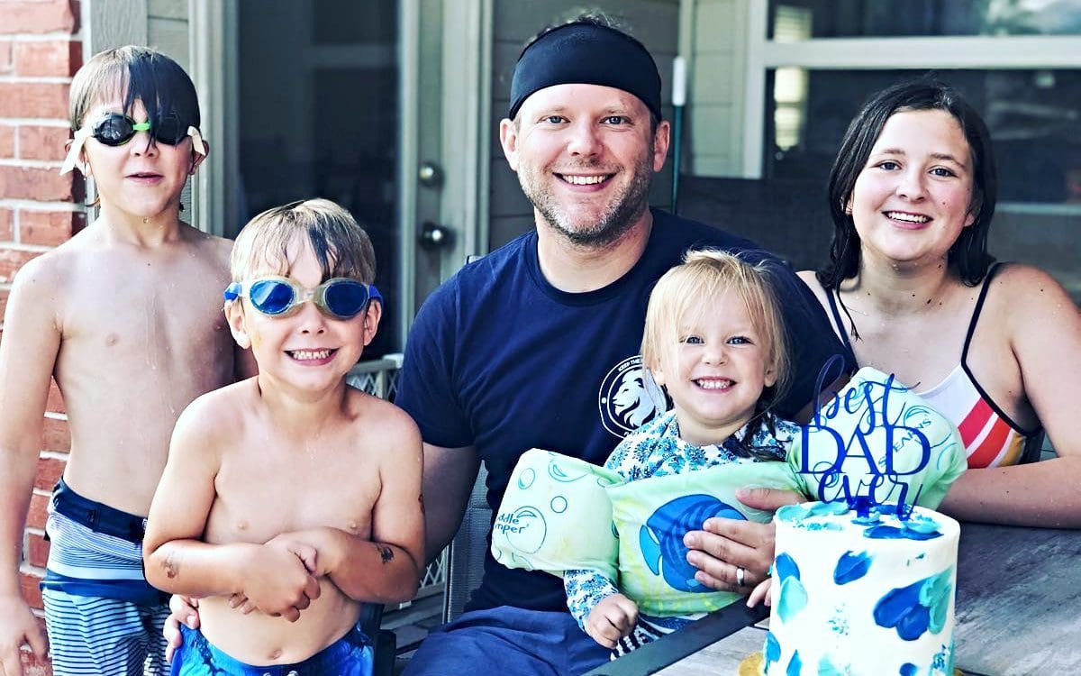 A family sitting on a back porch celebrating an event.