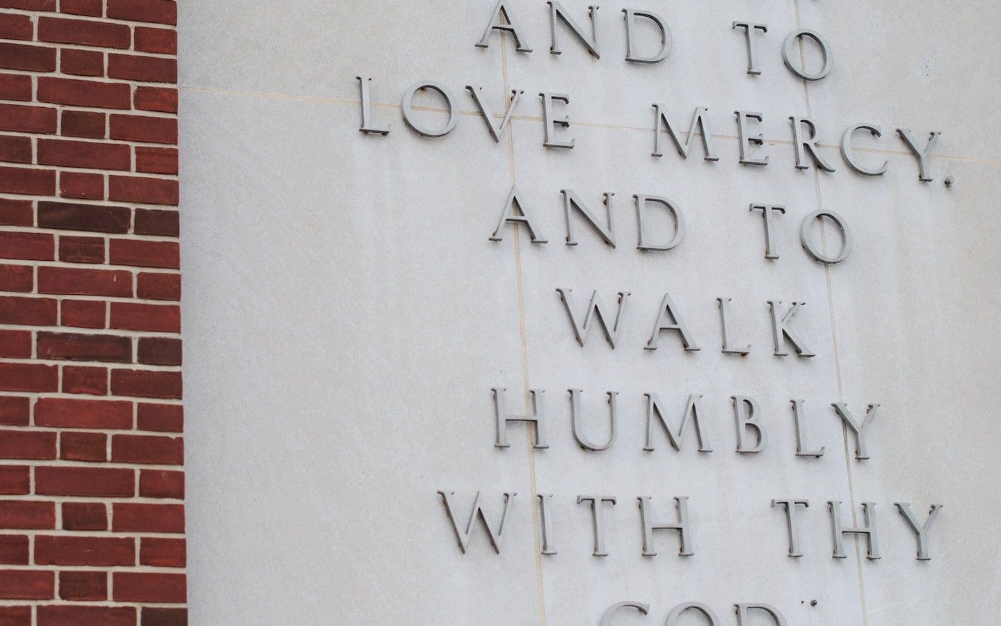 Part of Micah 6:8 displayed on a concrete wall.