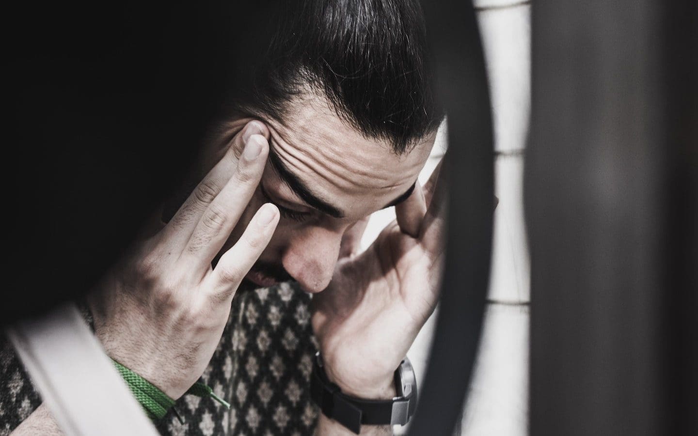 A man rubbing his temples.