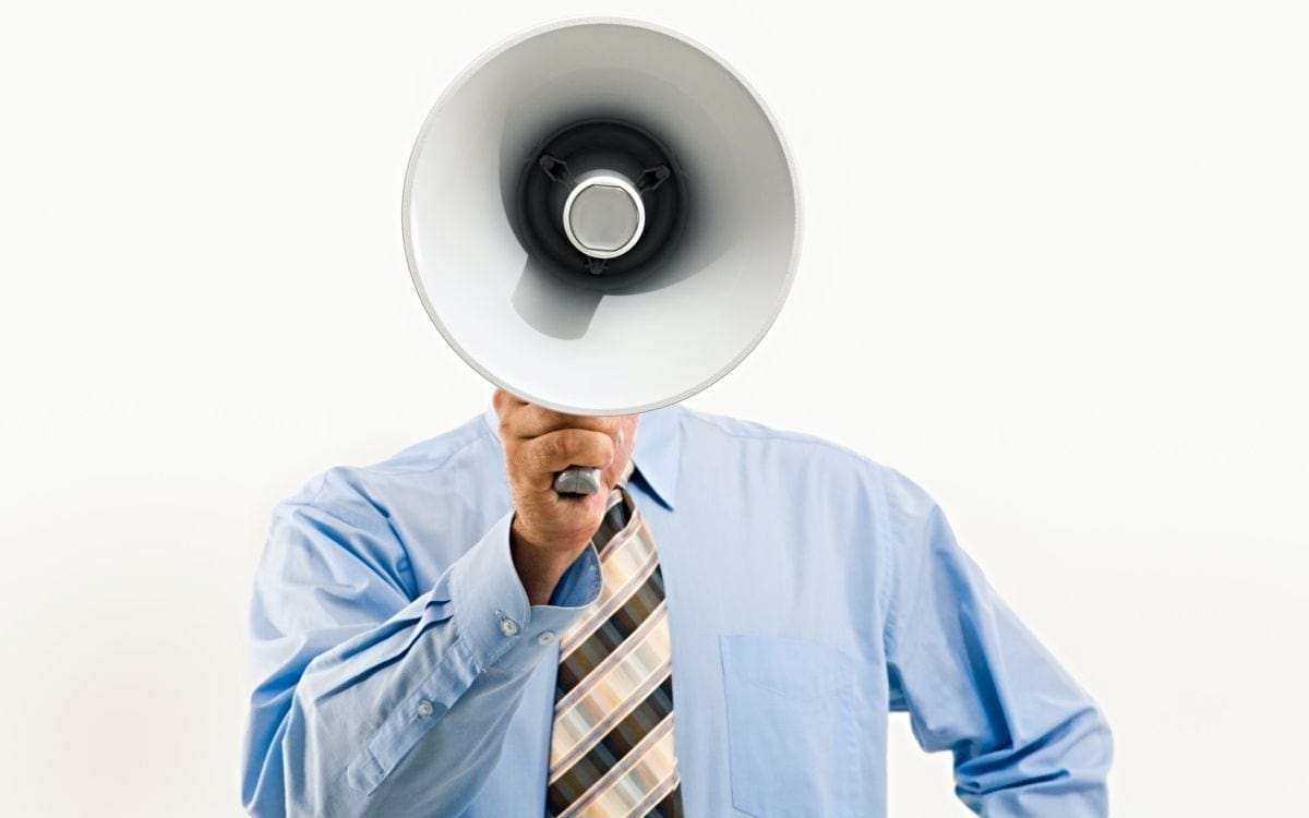 Many with megaphone in front of his head
